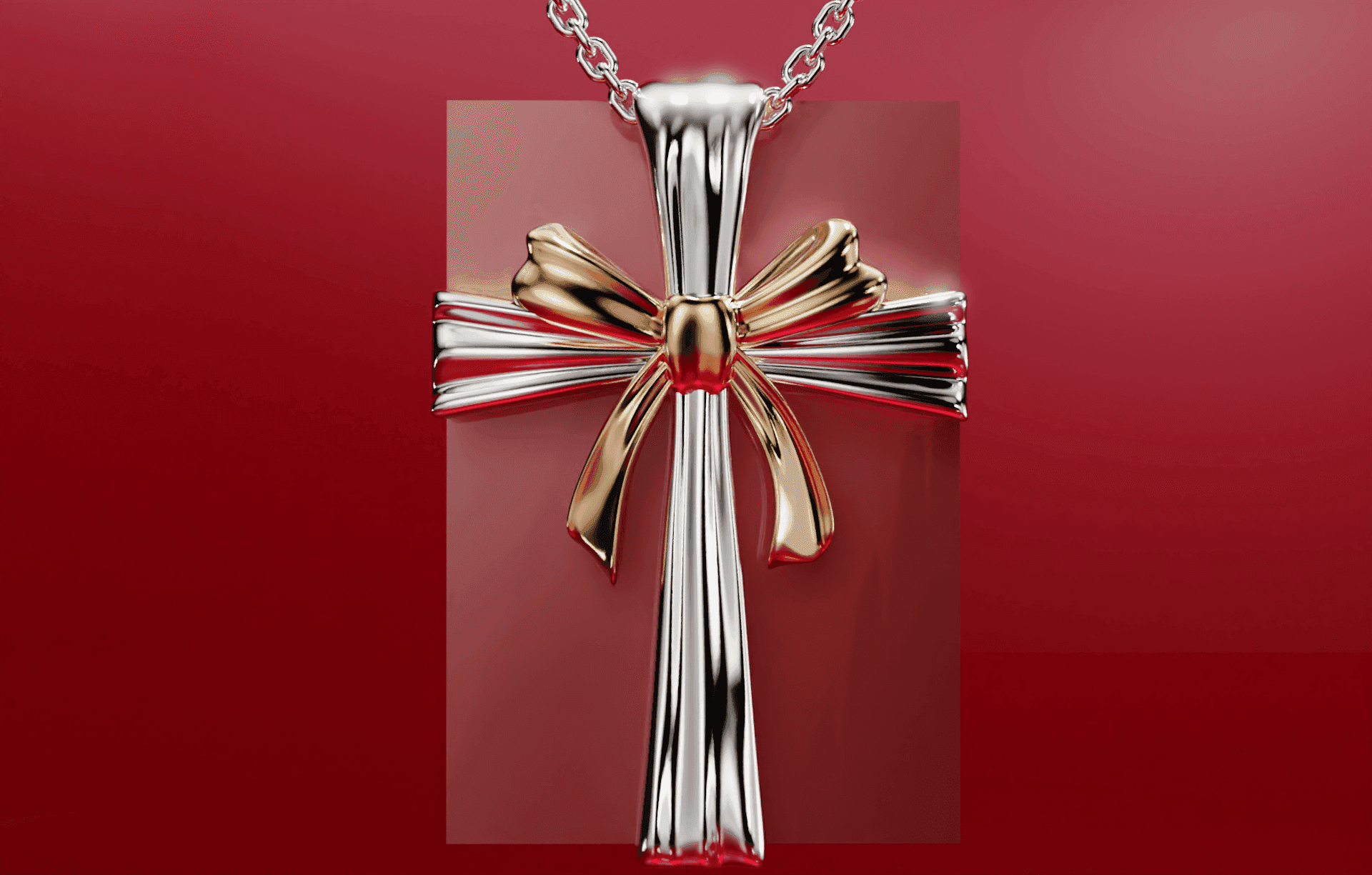 Elegant silver and gold cross pendant with a bow on a chain, set against a red background.